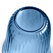Royal Copenhagen | Waves Water Glass, Blue, Set of 2: A fluted, translucent glass bowl with ribbed sides and an embossed mark, reflecting light against a white background.