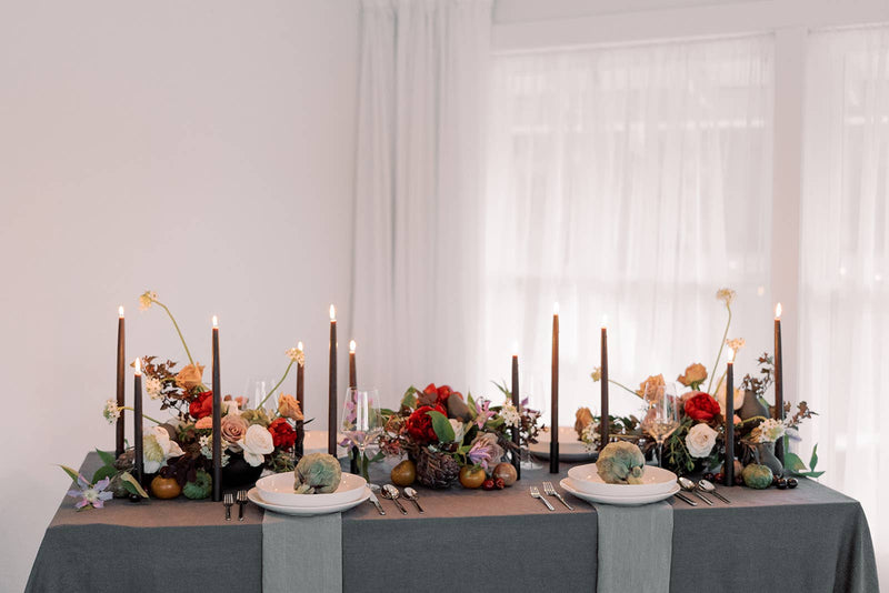 Mo&Co Home - Chestnut | Dipped Beeswax Taper Candles | All Natural: 14 Inch, elegantly illuminating a formal dining setup with floral arrangements, creating a moody, autumnal ambiance.