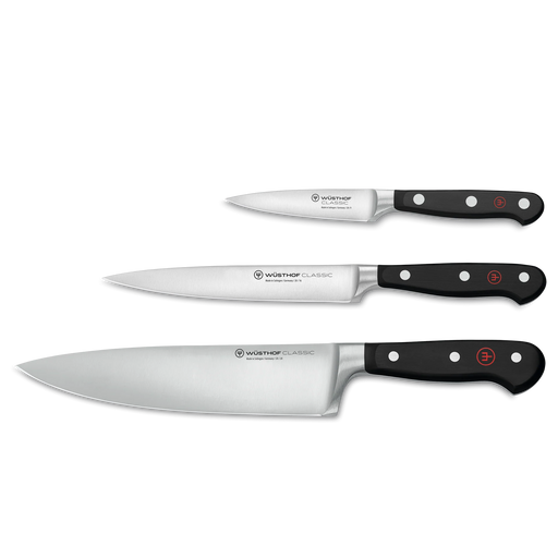 Wüsthof | Three Classic series kitchen knives showcasing paring, utility, and chef’s blades with full-tang, triple-riveted handles, ideal for versatile culinary tasks.