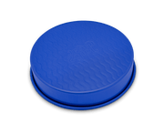 Great Jones | Patty Cake - Broccoli features a wavy, corrugated bottom for easy release and even baking, showcased in a round design suitable for any kitchen.