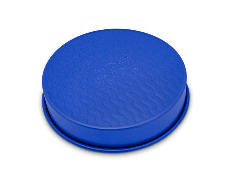 Great Jones | Patty Cake - Broccoli features a wavy, corrugated bottom for easy release and even baking, showcased in a round design suitable for any kitchen.