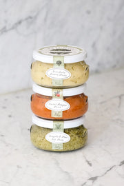 Bella Cucina | Chef's Selection Pesto Trio featuring three jars: Artichoke Lemon, Sweet Pepper, and Arugula Pine Nut Pestos, perfect for versatile culinary applications.