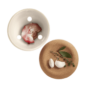 Emile Henry Garlic Pot in Burgundy, showcasing its ventilation design with garlic and herbs, ideal for preserving flavor and adding rustic elegance to kitchens.