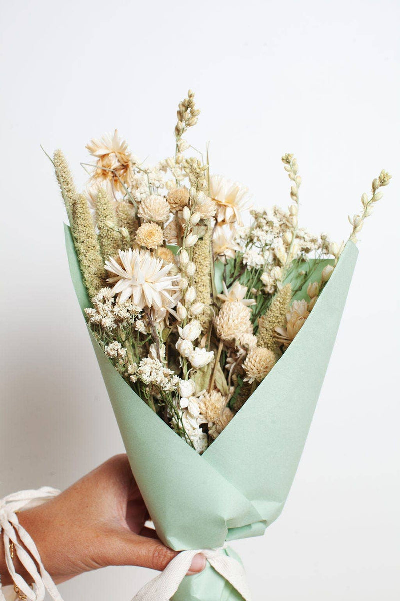 Idlewild Floral Co. - Sage Small Field Bouquet: Handheld bouquet of dried flowers in neutral tones wrapped in pale green paper with a white ribbon, perfect for kitchen decor.