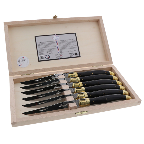 The French Farm - Jean Dubost 6 Steak Knives Black & Brass handles Clasp Box displayed open, showcasing knives with black handles and brass accents, inside a wooden presentation box.