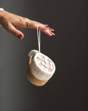 Farmhouse Pottery - Felted Silo Mug with Hot Cocoa Ornament, handcrafted in wool, held by a hand with painted nails. Features tiny felt marshmallows, perfect for cozy kitchen decor.