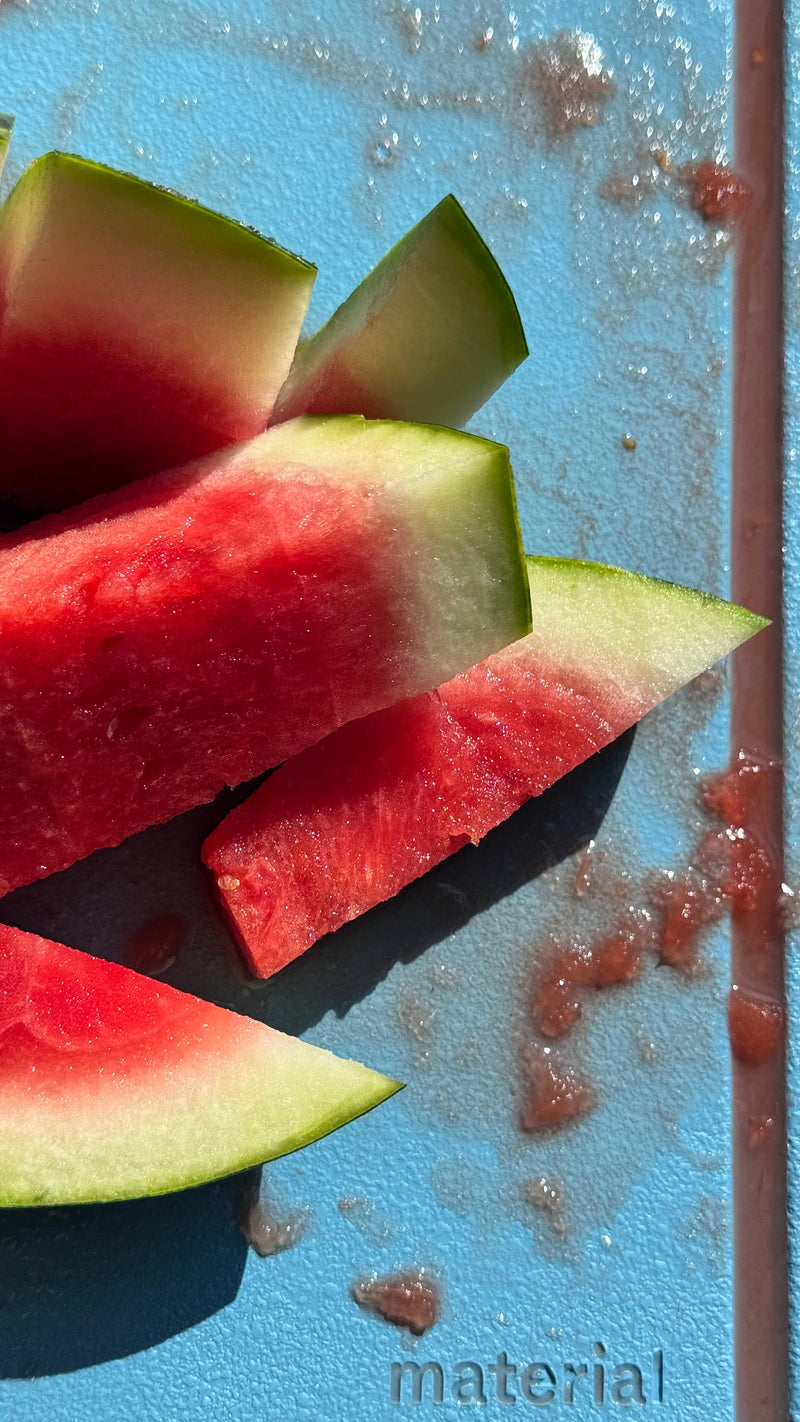 The MK Free Board: Cloud showcasing watermelon slices, highlighting its plant-based, non-porous surface and juice groove, ideal for precise, eco-friendly chopping.