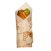 Bee's Wrap - Lunch 3 Pack - Honeycomb Print: A sandwich in a reusable, button-secured wrap, highlighting sustainable, eco-friendly food storage for lunches on the go.
