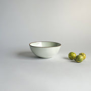 Sarah Kersten - Ramen Bowl: Inverness, featuring a white bowl with a brown rim, perfect for noodles or salads, shown alongside watermelons on a white surface.