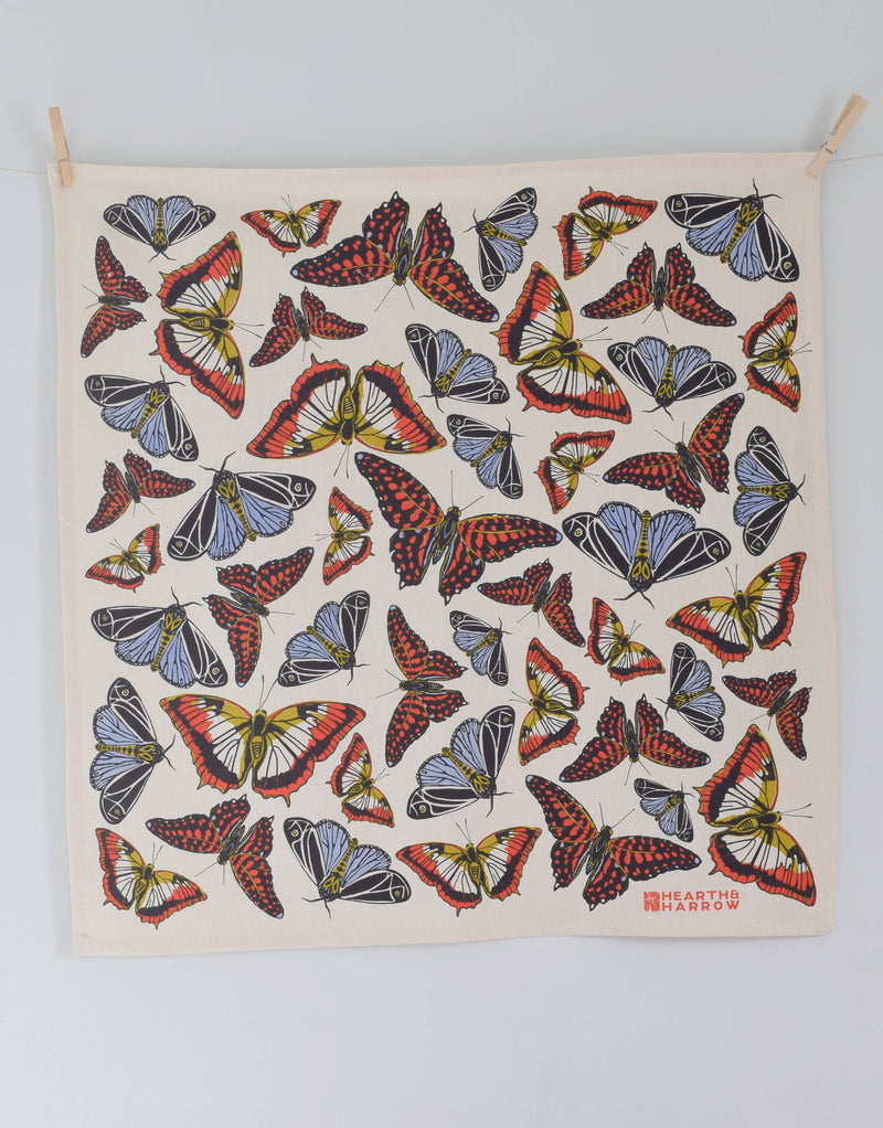 Hearth and Harrow - Butterfly Tea Towel: Organic cotton towel with red, yellow-cream, black, and blue butterfly pattern, clipped at corners. Eco-friendly, 30x30, designed in Rockport, Maine.