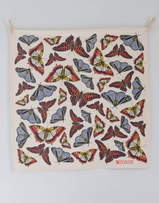 Hearth and Harrow - Butterfly Tea Towel: Organic cotton towel with red, yellow-cream, black, and blue butterfly pattern, clipped at corners. Eco-friendly, 30x30, designed in Rockport, Maine.