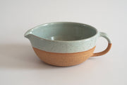 RachaelPots - Salad Dressing Bowl: Pink, speckled stoneware with handle and pour spout, ideal for dressings or guacamole, featuring a garlic scraper.