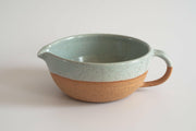 RachaelPots Salad Dressing Bowl - Nude; a versatile hand-thrown pottery piece with a garlic scraper, handle, and pour spout, perfect for dressings or guacamole.