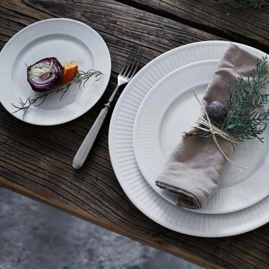Pillivuyt | Plisse Plate - 8.5 with a fork and napkin, showcasing elegant pleats, ideal for salads or starters.
