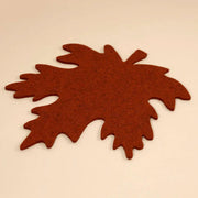 Graf Lantz | Merino Wool Autumn Trivet - Mahogany displayed on a white surface, showcasing a sophisticated felt leaf design for elegant kitchen presentations.