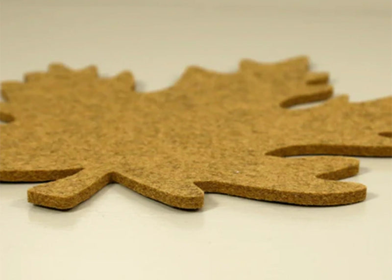 Graf Lantz | Merino Wool Autumn Leaf Trivet - Ochre on display, showcasing its protective, heat-resistant qualities on a white surface.