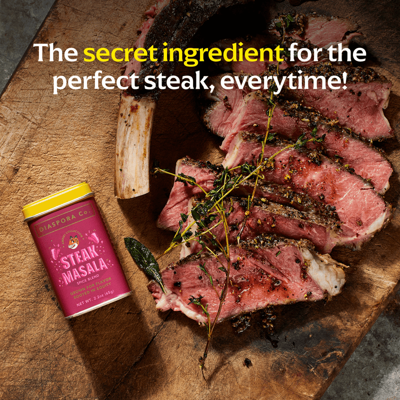 Diaspora Co. Spices - Steak Masala on a cutting board, showcasing a blend perfect for enhancing steak flavor with smoky umami and herbaceous depth.