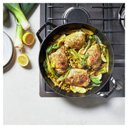 Staub | 12-inch Cast Iron Braiser With Glass Lid - Citron, showcasing a durable, enameled cast iron design with a domed glass lid for moisture retention.
