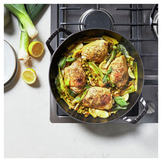 Staub | 12-inch Cast Iron Braiser With Glass Lid - Citron, showcasing a durable, enameled cast iron design with a domed glass lid for moisture retention.