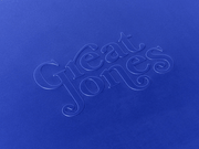 Great Jones | Little Sheet - Pepper: A close-up of elegant blue calligraphy on a quarter-sized, nonstick sheet pan, ideal for small baking tasks.