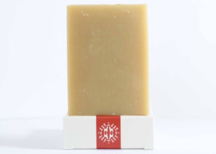 Little Seed Farm Orange Vetiver Bar Soap, featuring organic Sweet Orange and Vetiver oils, offers a soothing, citrusy aroma for a calming bath experience.