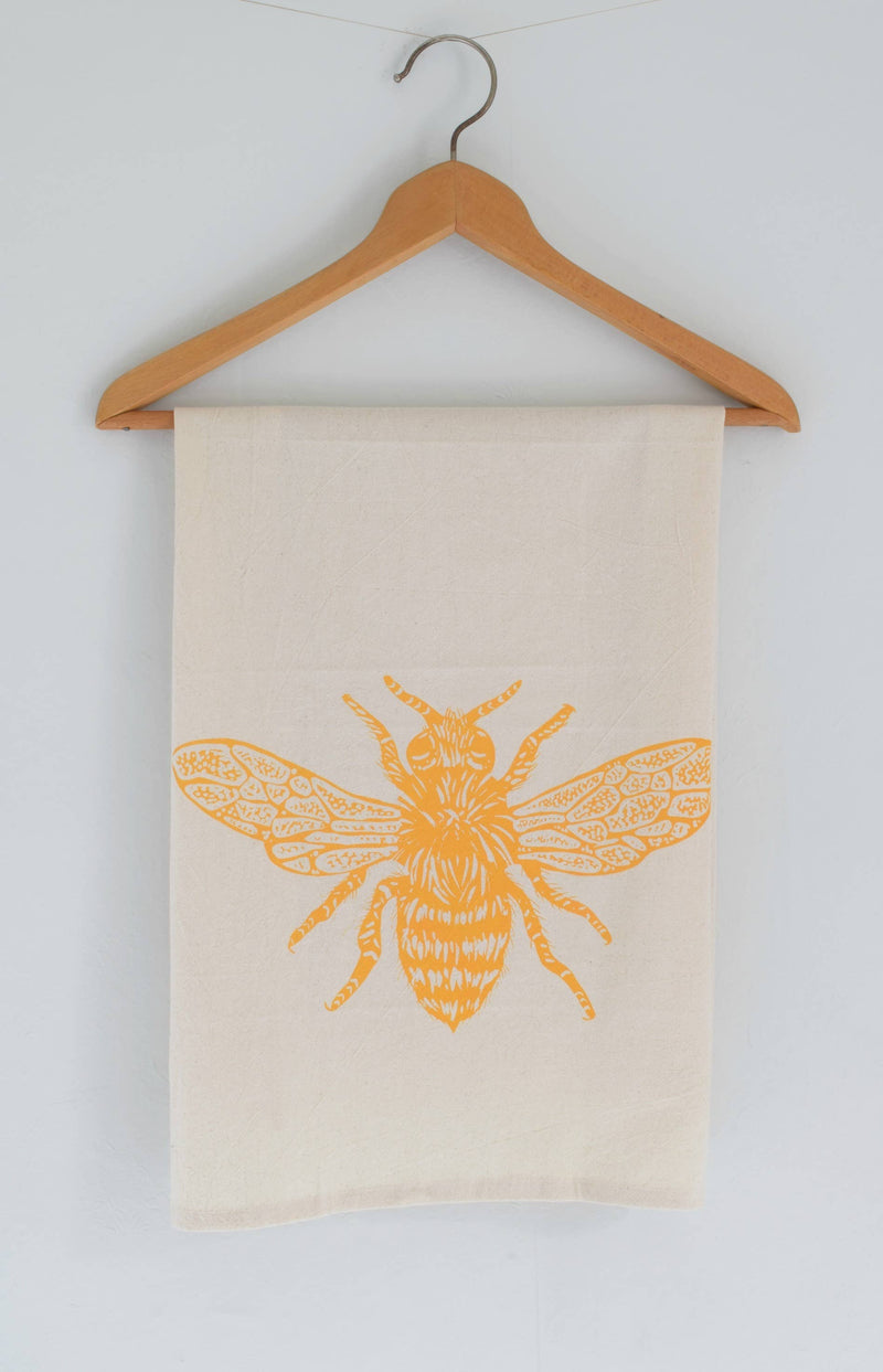 Hearth and Harrow Honeybee Tea Towel in organic cotton, featuring a yellow bee design. Screen printed, eco-friendly, with a hanging loop. Perfect for kitchen use.
