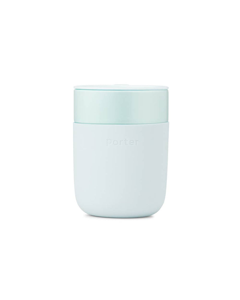 Reusable ceramic mug with a blue splash-resistant lid, featuring a silicone sleeve for grip. Ideal for coffee or tea, 16 oz capacity.