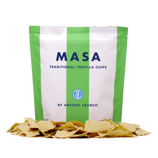 Ancient Crunch | MASA Traditional Tortilla Chips, Lime in a white bag with chips in front, showcasing zesty flavors and handmade quality, ideal for sharing.