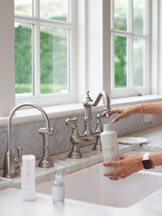 L'AVANT Collective - Fresh Linen Multipurpose Cleaner Refill being poured into a sink, showcasing its eco-luxe packaging and ease of use for sustainable cleaning.