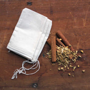 Oliver Pluff & Company - Orange Clove Hot Toddy Kit with muslin bag, cinnamon sticks, and dried roots, ideal for creating warm, spiced beverages.