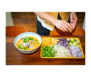 Close-up of a hand displaying the Great Jones | Little Sheet - Pepper, a quarter-sized baking pan ideal for small batches, showcasing its nonstick, nontoxic surface.