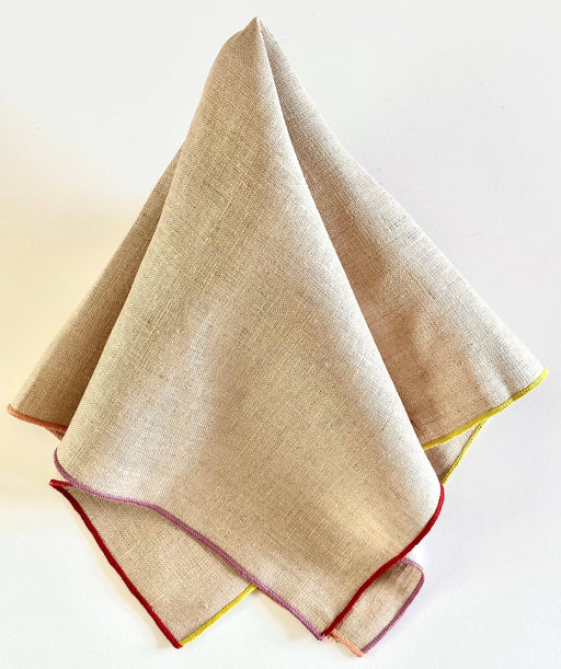 Tisch New York - Napkins, Natural Linen (Jewel Hem) folded, showcasing vibrant overlock stitches on edges. Sold in sets of four, ideal for kitchen elegance.