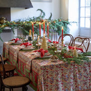 Couleur Nature - Noel Red & Green French Tablecloth on a festive dining table with holiday decor, candles, and elegant place settings, creating a cozy Christmas atmosphere.
