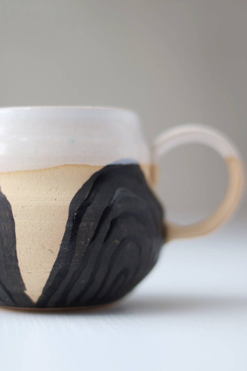 Gravesco Pottery - Transformation Mug Petite, a handmade ceramic mug with a textured body and smooth white rim, embodying feminine strength and transformation.