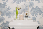 L'AVANT Collective - Blushed Bergamot Room Spray 100 ml, elegantly displayed beside a candle and flower, perfect for enhancing any room's ambiance.