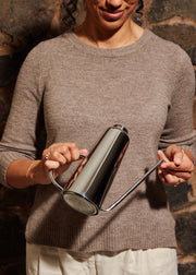 Holcomb Studio Oil Can held by a woman, featuring a sleek design with an elongated spout for precise, drip-free pouring, ideal for kitchen use.