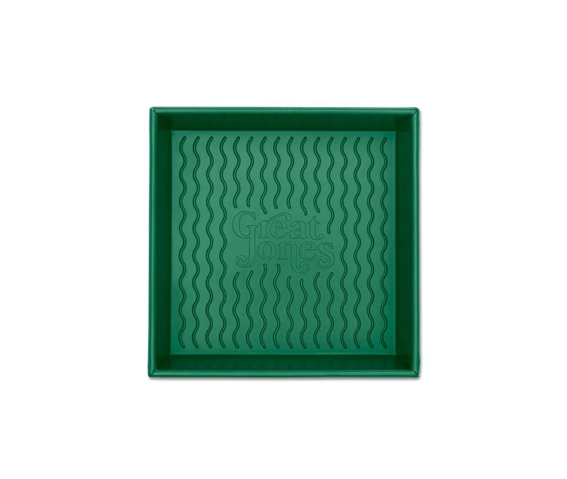 Great Jones | Square One - Blueberry: A 9x9-inch baking pan with a wavy, nonstick bottom for easy release and even baking, perfect for any kitchen.