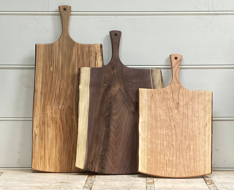 Petermans Boards and Bowls Inc. - 27 Ambrosia Maple Serving Board with Handle, showcasing a handcrafted, sustainably sourced design perfect for elegant serving or display in any kitchen.