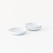 Sarah Kersten - Olive Dish: Basin Collection: Winter Mesa, featuring a stack of elegant, versatile white plates and bowls suitable for appetizers or side servings.