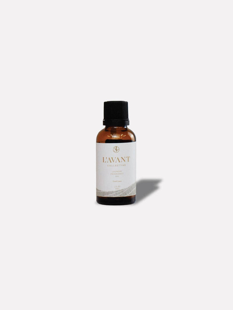 L'AVANT Collective - Fresh Linen Laundry Oil in a brown bottle with a white label, ideal for enhancing laundry with a natural scent.