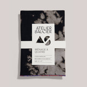 ATELIER SAUCIER - Sundown Linen Napkins | Set of 4: Black-and-gray mottled cloth napkins made from reclaimed fabric, neatly packaged with brand label.