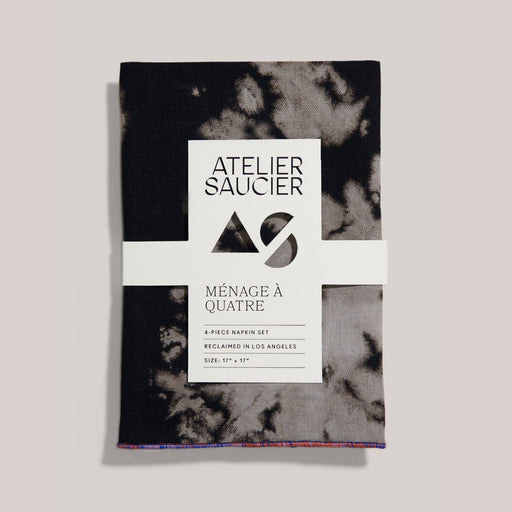 ATELIER SAUCIER - Sundown Linen Napkins | Set of 4: Black-and-gray mottled cloth napkins made from reclaimed fabric, neatly packaged with brand label.