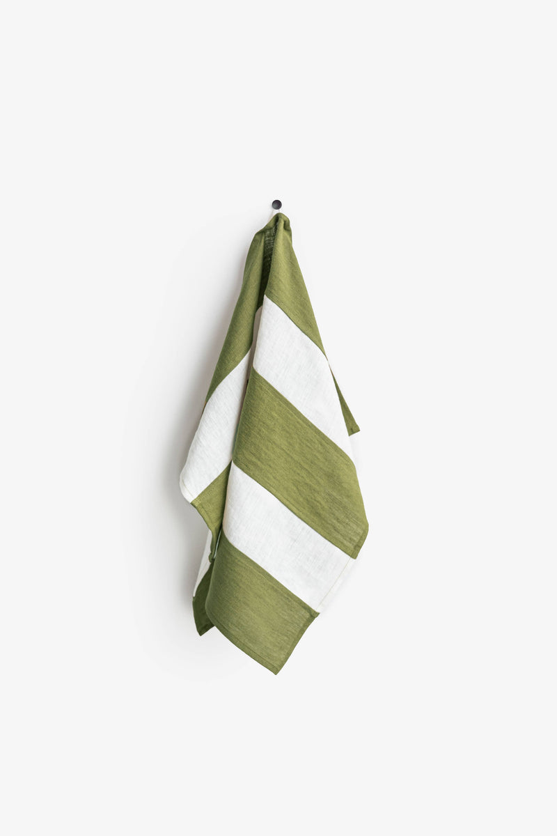 MagicLinen's striped linen tea towel on a hook, showcasing its hanging loop feature. Part of a zero-waste program, perfect for stylish and eco-friendly kitchens.