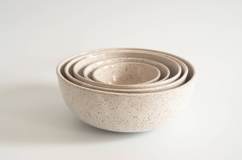 Nesting bowls set of five stacked together, showcasing various sizes of hand-thrown, speckled stoneware bowls from RachaelPots, ideal for food prep and serving.