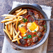 Villa Jerada - Shakshuka Blend - 50g showcased in a rustic dish with meatballs, baked eggs, and herbs, accompanied by French fries, ready to serve.