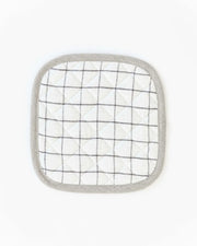 MagicLinen - Linen pot-holder: A white and black plaid, square-shaped pot holder with quilted detailing and a hanging loop, perfect for kitchen heat protection.