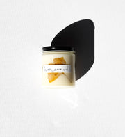 Among the Flowers | Essential Oil Candle, Homeward in a glass jar with black lid, featuring soy wax and dried botanicals, labeled “homeward.”