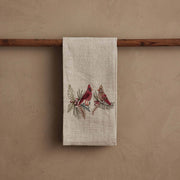 Coral & Tusk - Christmas Cardinals Tea Towel features embroidered cardinals on pine and holly, draped over a wooden rod, perfect for gifting.