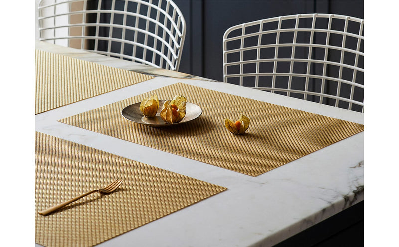 Chilewich | Basketweave Rectangle Placemats - Bon Bon - 14 x 19 displayed on a table, featuring physalis on a plate, highlighting its textured weave and versatile design.