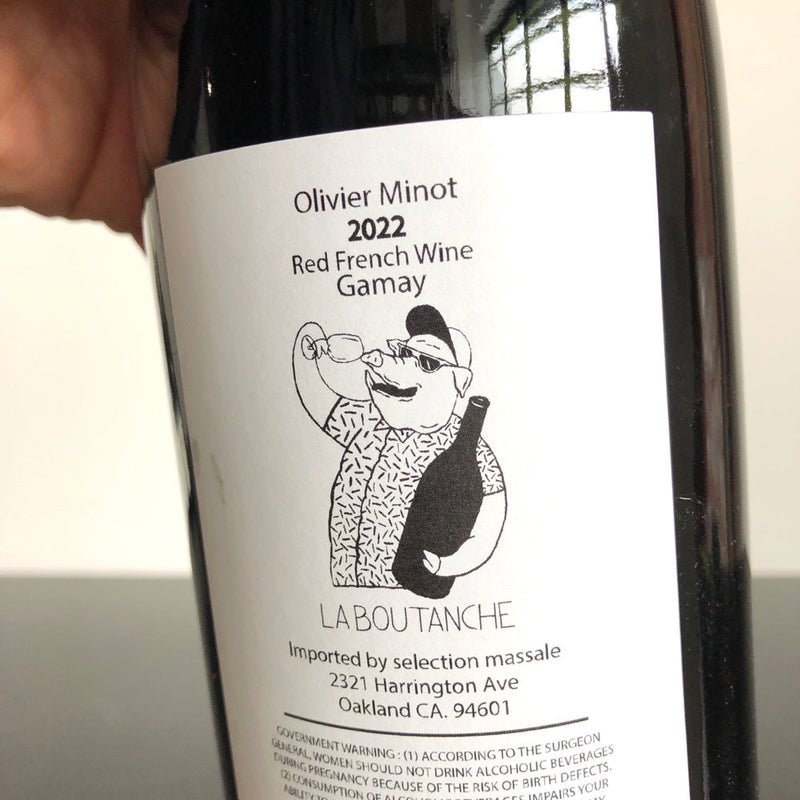 La Boutanche | Gamay by Olivier Minot bottle held in hand, showcasing its natural winemaking and vibrant flavor, ideal for wine enthusiasts.
